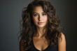 © Synthetica - Portrait of beautiful young woman with long curly hair on grey background.