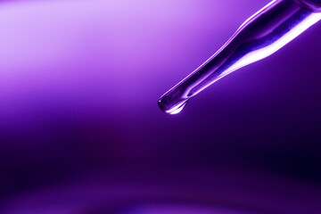 Wall Mural - test tube, medical or science laboratory concept, liquid droplets with droplets in purple tone backg