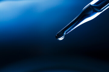Wall Mural - water droplets macro science experiment,liquid drop from laboratory glass pipette