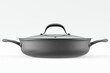 Stainless steel frying pan with glass lid and chrome cookware on white