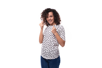 Wall Mural - portrait of a pretty curly young brunette woman with shoulder length hair dressed in a short sleeved shirt