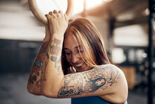 Smiling Woman Holding A Ring During A Workout In A Gym
