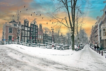 Poster - City scenic from snowy Amsterdam in the Netherlands at sunset