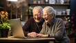 Beautiful caucasian senior couple with eyeglasses browsing together on laptop sitting at home, old retirees people enjoying tech and social