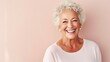 © iuricazac - Joyful senior strikes a pose against a serene pastel studio.