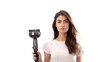 © Dilshad - An isolated image of a female hairstylist with a hair dryer and brush on a stark white background