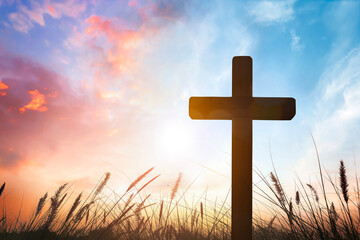 Wall Mural - the cross on grass with sunset in the sky background
