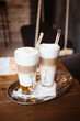 Morning coffee break - glass of latte macchiato and wiener melange coffee