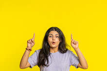 Indian Woman Showing Thumbs Up Pointing Overhead, Above Head Empty Place, Advertising Area For Commercial Text Copy Space For Goods Promotion Advertisement. Arabian Girl Isolated On Yellow Background
