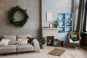 Wall Mural - Interior of a country house with a fireplace, couch, Christmas tree, a wicker chair and decor for the new Year