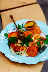 Wall Mural - Halloumi cheese with apricots on an outdoor grill