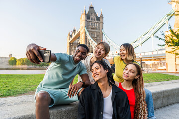 Multiracial group of happy young friends bonding in London city - Multiethnic teens students meeting and having fun in Tower Bridge area, UK - Concepts about youth lifestyle, travel and tourism