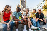 Fototapeta Fototapeta Londyn - Multiracial group of happy young friends bonding in London city - Multiethnic teens students meeting and having fun in Tower Bridge area, UK - Concepts about youth lifestyle, travel and tourism