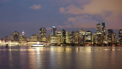 Wall Mural - View of buildings illuminated in the city on coastline from stanley park at Vancouver