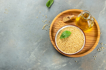 Wall Mural - Ptitim or Birdy, Israeli pasta couscous on a light background top view. copy space