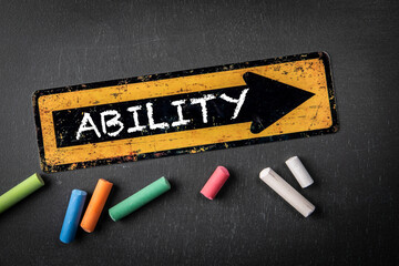 Wall Mural - ability concept. direction arrow with text on a dark chalkboard background