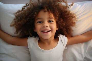 Aufkleber - A peaceful image of a little girl laying in bed with a pillow. This picture can be used to depict relaxation, sleep, comfort, or childhood.
