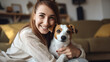 © Studio Nova - Happy woman hugging a Jack Russell Terrier dog, both looking towards the camera with a cozy home setting in the background.