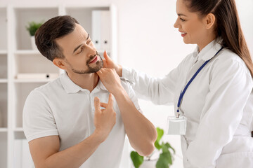 Canvas Print - Female physiotherapist working with young man in rehabilitation center