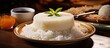 In City, an Asian cuisine aficionado prepared a white cake made with healthy ingredients like rice and coconut, plated with a bamboo base, and topped it with a natural egg-based dessert, low in sugar