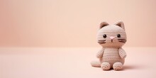 Pink Knitted Kitty On A Pastel Pink Background With Copy Space.