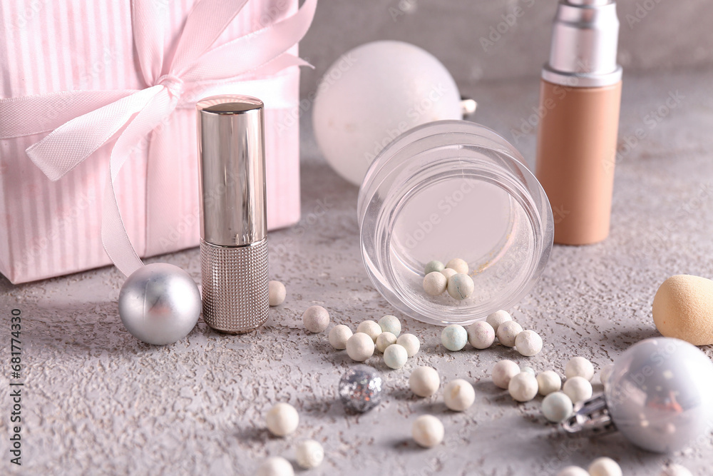 Christmas composition with makeup products on grey background, closeup