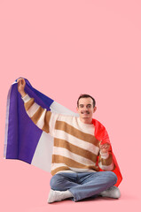 Sticker - Handsome man with flag of France sitting on pink background