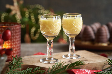 Eggnog in two shot glasses with wasp nests - Czech Christmas cookies in the background