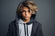 Portrait of a teenage boy in a hooded sweatshirt.