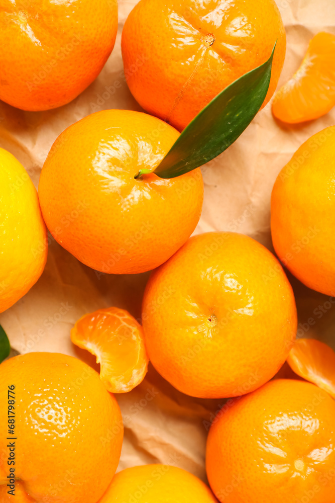 Many sweet mandarins with leaf on paper, closeup