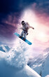 © beshoy - Snowboarder launching off a jump, slitting man on ice mountain flying on air
