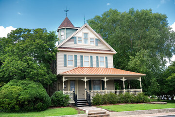 Wall Mural - big classic american two level house with terrace and lawn in the front yard.