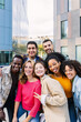 © Xavier Lorenzo - Vertical portrait of young group of diverse people smiling at camera outdoors. Happy millennial college students enjoying time together, social gathering and hanging out at city street.