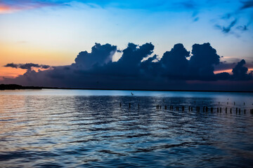 Poster - orange clouds at sunrise over the lake