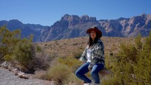 Young Woman In A Western Style Outfit Exploring The Amazing Red Rock Canyon In Nevada - Travel Photography