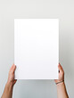 Hand holding blank photo frame board mockup on minimalist white background created with Generative AI Technology
