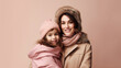Mother and daughter wearing warm winter clothes