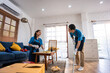 Asian young man and woman cleaning service worker work in living room.