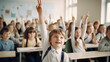 © Tierney - Pupils raising their hands during class at the elementary school