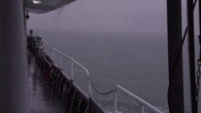 Water Falls Off Ferry Boat Deck Sailing In Foggy Rain Storm