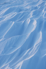 Wall Mural - snow texture. wind sculpted patterns on snow surface. wind in the tundra and in the mountains on the