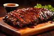 close-up of bone-in ribs smothered in dark bbq sauce