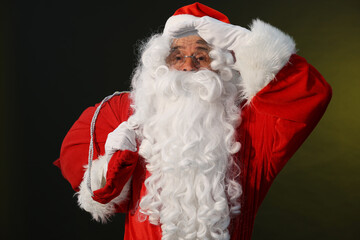 Canvas Print - Merry Christmas. Santa Claus with bag on dark background