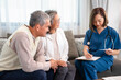 asian senior couple talking with a home visiting nurse,young female nurse measuring the mercury and taking notes,concept of elderly people lifestyle,homecare,home health nursing