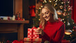 © boti1985 - Model opening christmas present with a christmas bokeh background