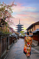 Poster - Young Japanese woman in traditional Kimono dress with Yasaka Pagoda at Hokanji temple in Kyoto, Japan during full bloom cherry blossom in spring