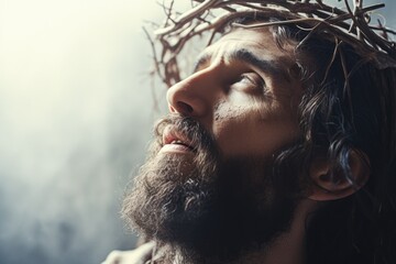 Fototapeta jesus with bloody crown of thorns on his head over light background. jesus christ in agony praying before crucifixion. good friday, passion, easter concept. gospel, salvation