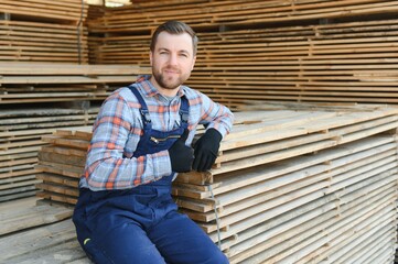 Wall Mural - Joiner in uniform check boards on timber mill