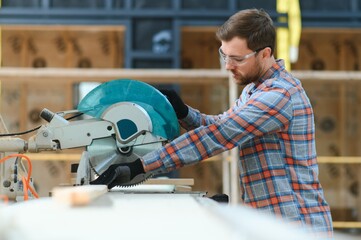 Wall Mural - Carpenter working with equipment on wooden table in carpentry shop.