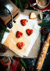 Christmas cookies with strawberry jam, heart-shaped. Top view